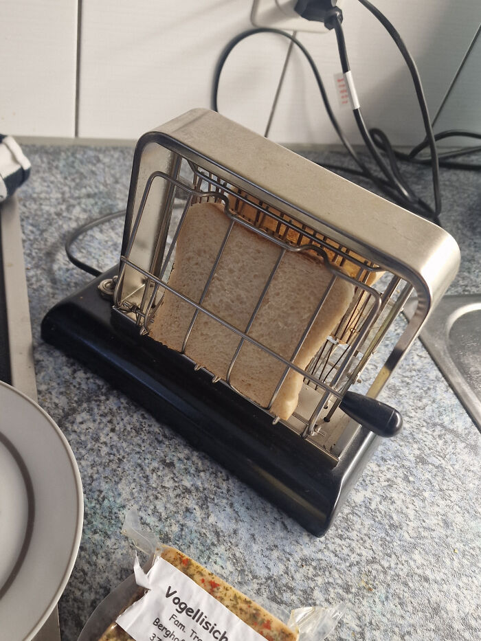 Vintage toaster with one slice of bread on kitchen counter