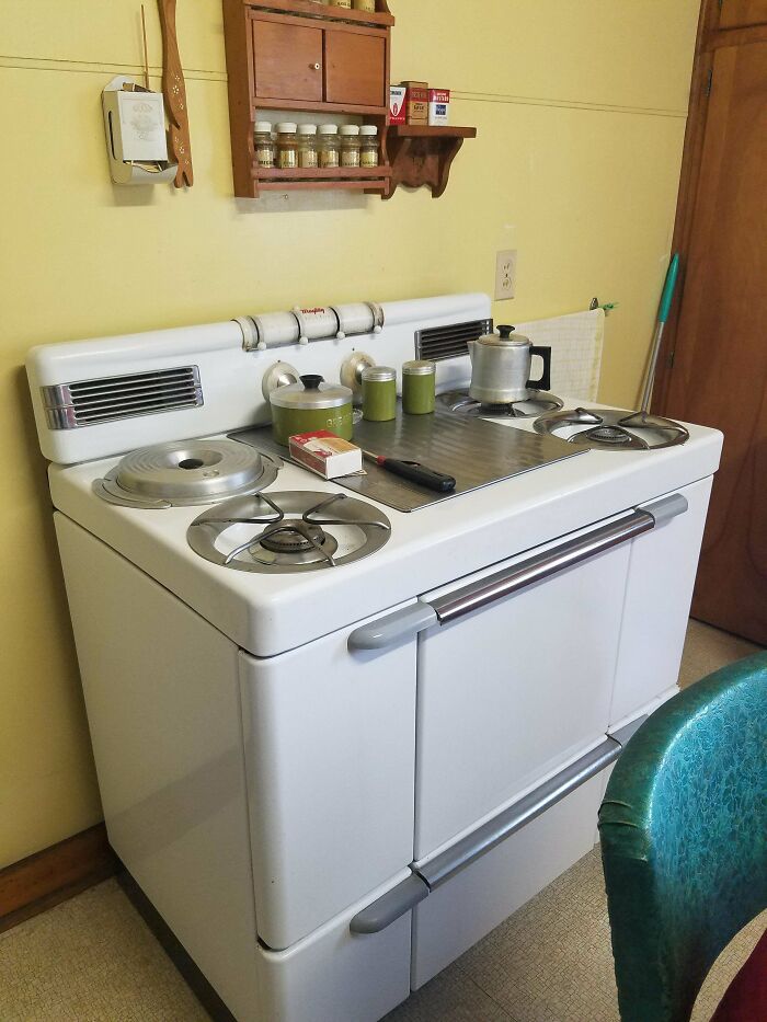 Classic mid-20th century vintage kitchen stove with pots and utensils