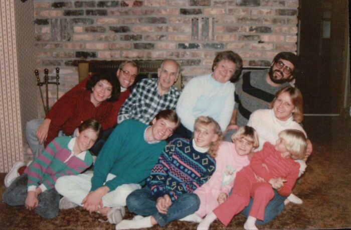 90s family posing together indoors wearing casual clothes
