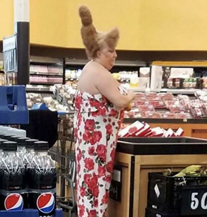 Woman with unique tall hairstyle shopping in Walmart grocery aisle