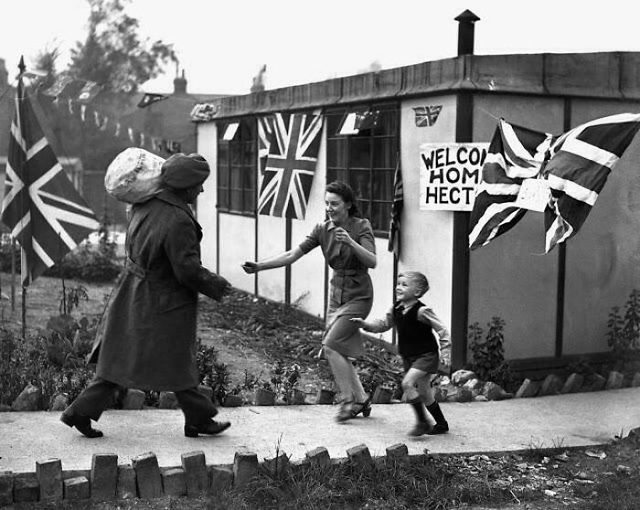 Rare historical photo of family welcoming soldier home with Union Jack flags