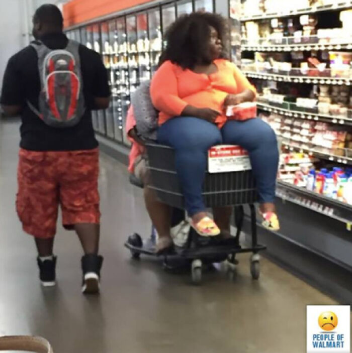 Woman sitting in motorized cart at Walmart aisle with frozen products