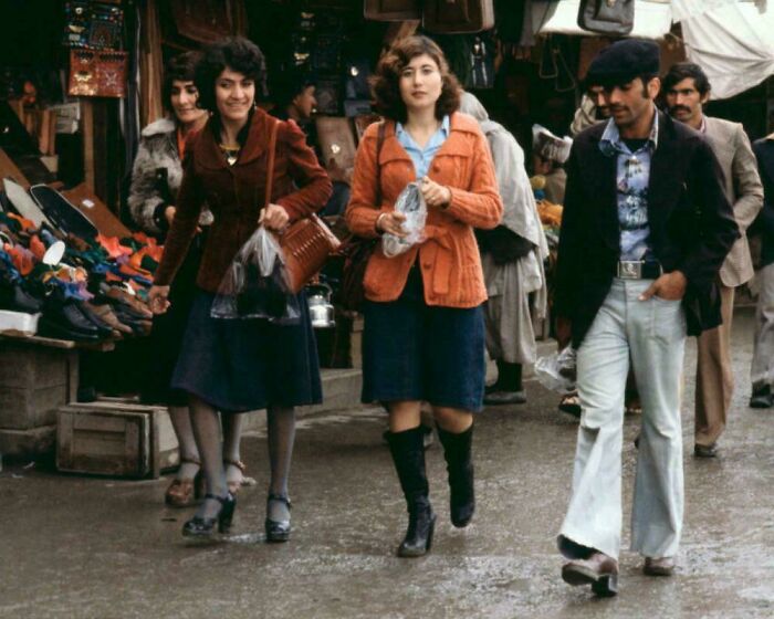 Rare historical photo of people walking and shopping at an outdoor market in the 1970s