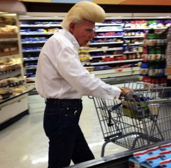 Man with exaggerated pompadour hairstyle shopping at Walmart