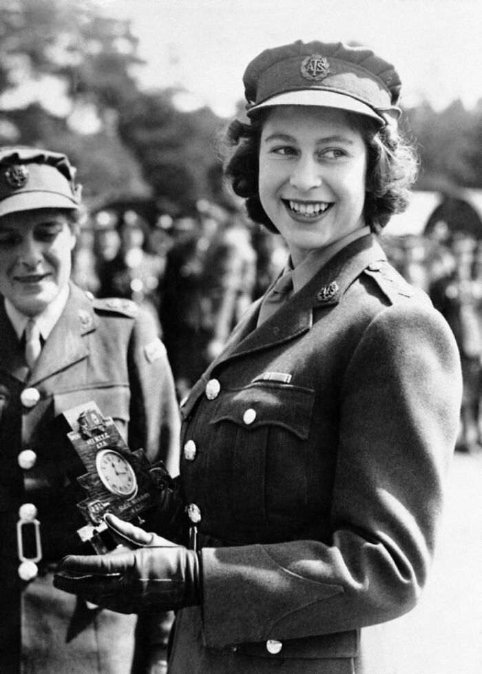 Historic photo of a young woman in military uniform smiling during World War II