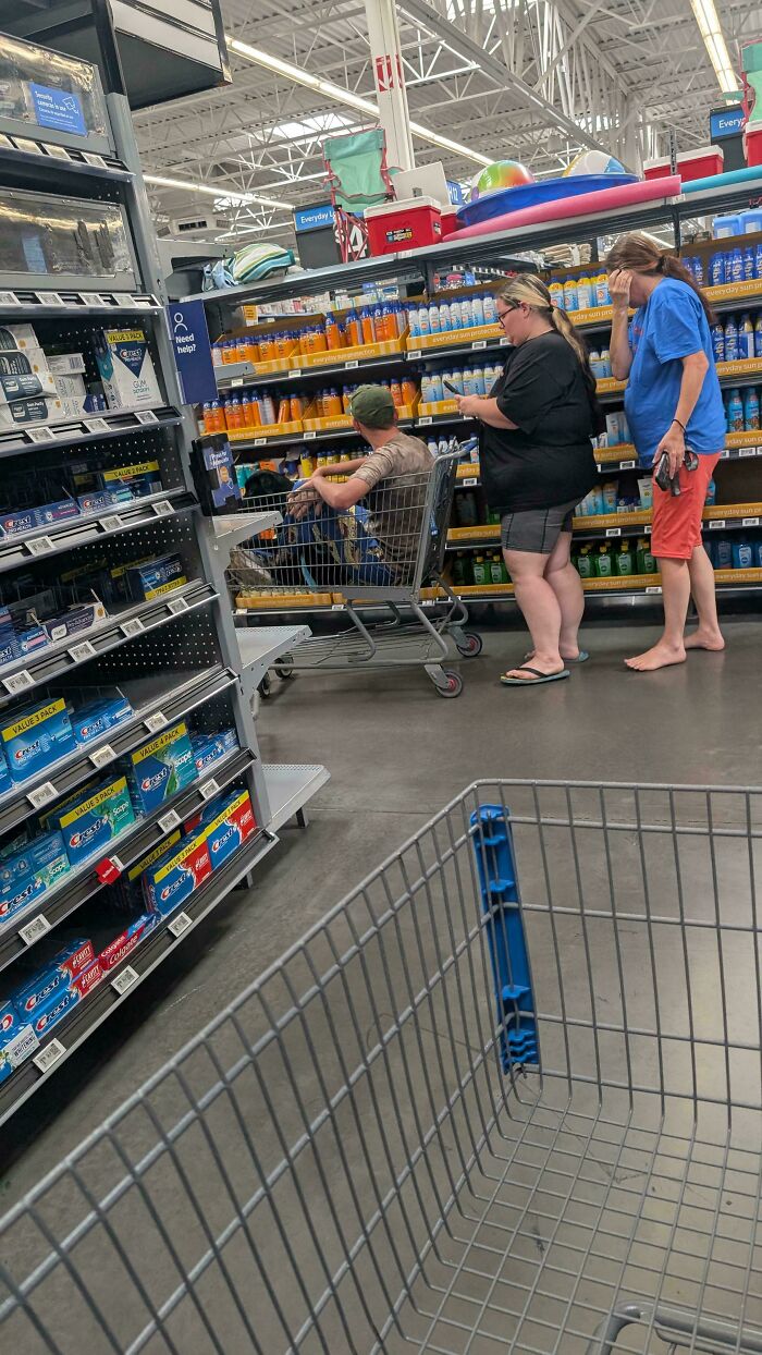 People shopping for sun protection products in Walmart aisle