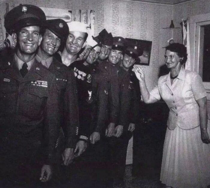 Vintage rare historical photo showing soldiers smiling with a woman indoors