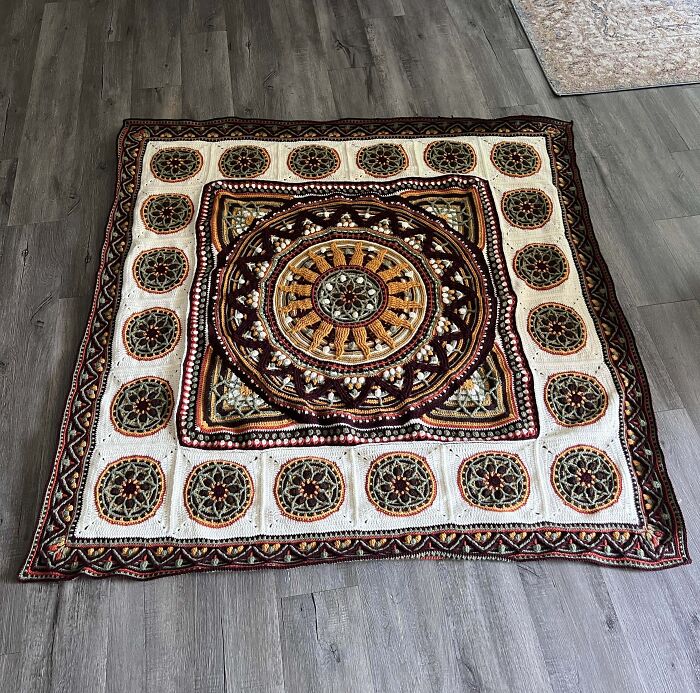 Intricate crochet blanket with circular mandala patterns in yarn