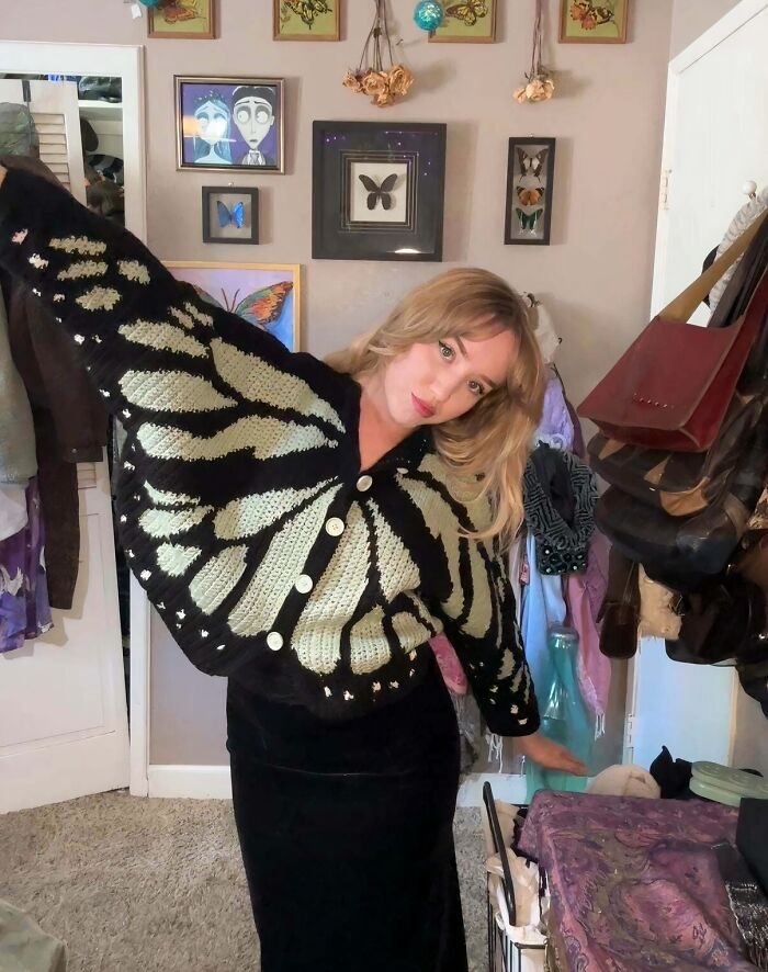 Woman wearing a butterfly wing inspired crochet sweater
