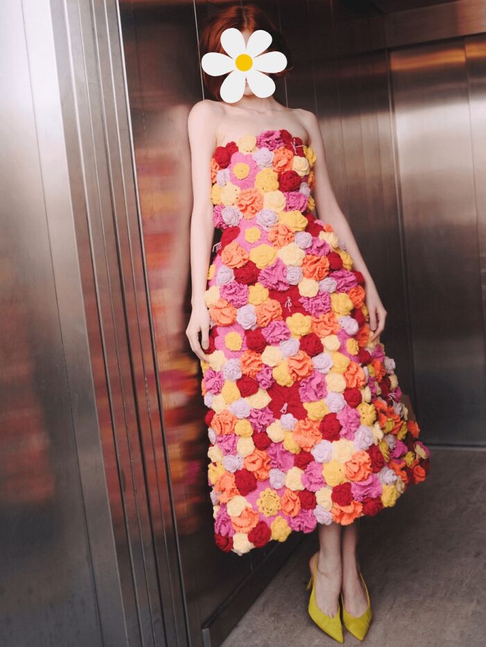Woman wearing a floral crochet dress with multicolored flowers