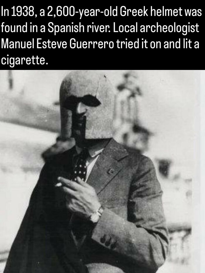 An archaeologist wearing an ancient Greek helmet while smoking, featured in fascinating photos and facts about history.