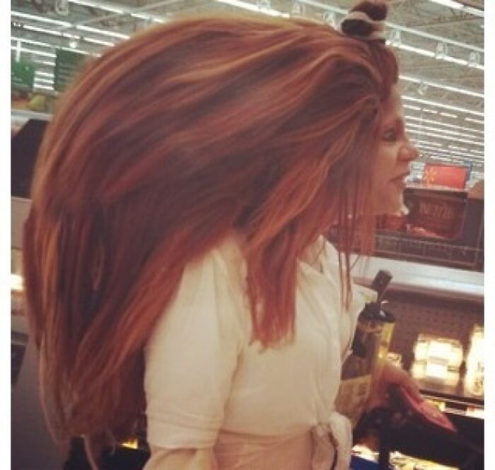 Woman with extremely large hair in Walmart