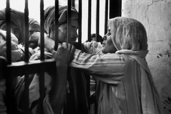 Emotional moment through prison bars in rare historical photo