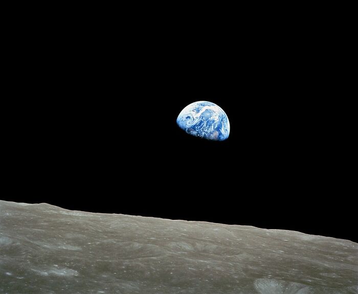 Rare historical photo of Earth rising over moon horizon in space