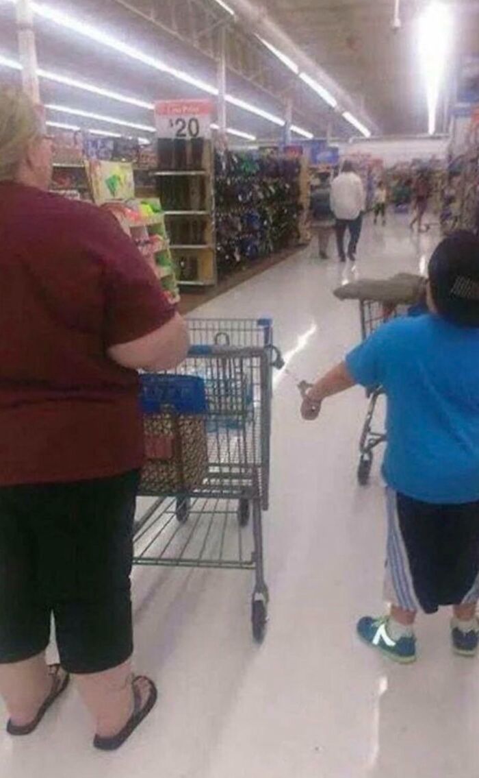 People shopping inside Walmart aisle with carts