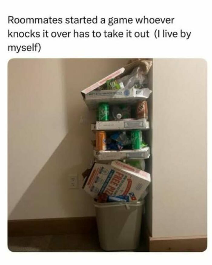 Strange and funny pics showing an extraordinarily tall stack of trash filled to the ceiling over a small bin.