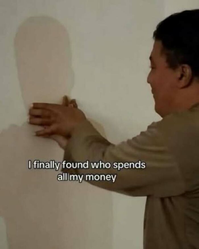 Funny pics meme of a man grabbing his own shadow on a wall