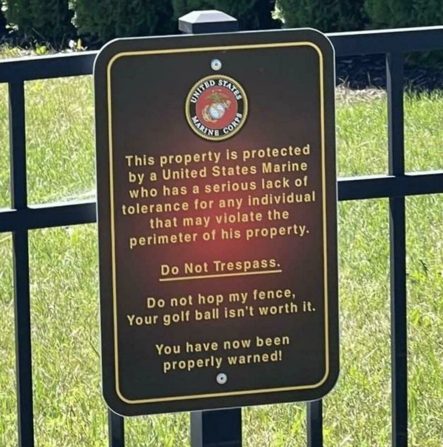 Sign warning trespassers property protected by a Marine with low tolerance