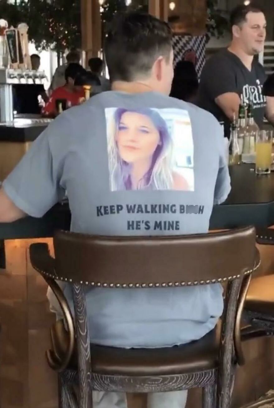 Man wearing a shirt with a photo and text claiming ownership in a tough online look fail