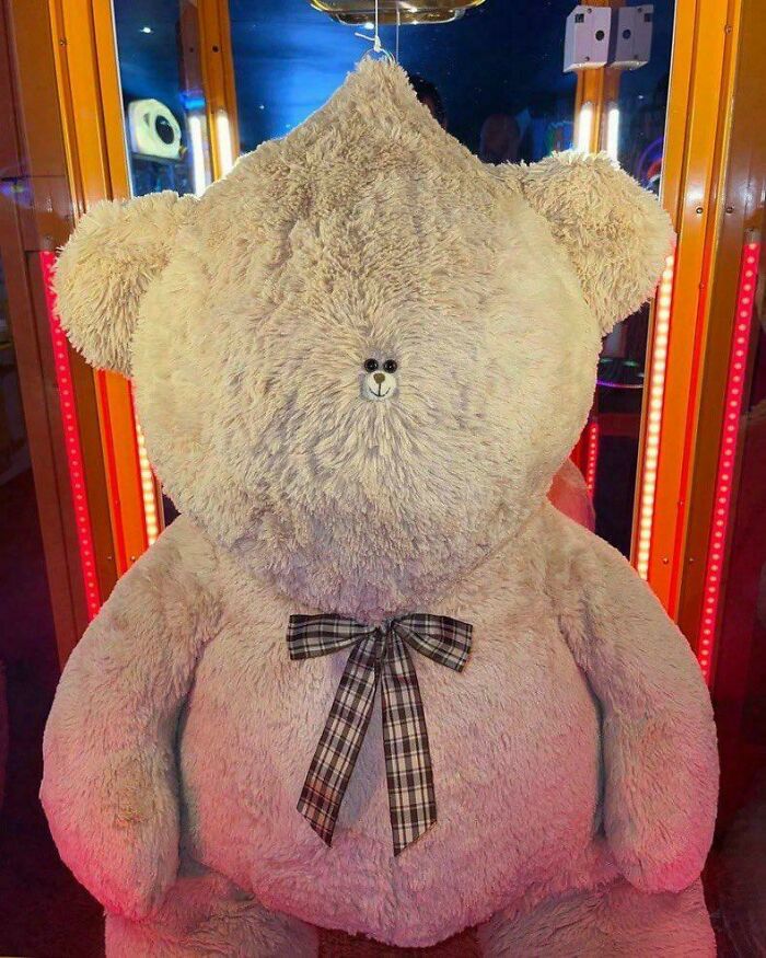 Giant teddy bear missing face except small nose eyes weird cursed image