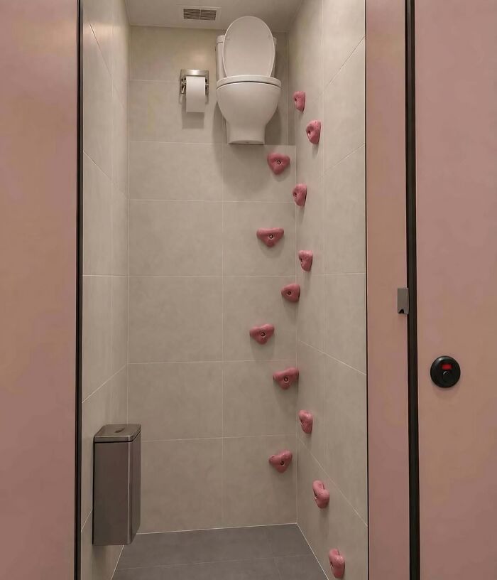 Hilarious pics of a toilet mounted at the top of a rock climbing wall inside a stall.