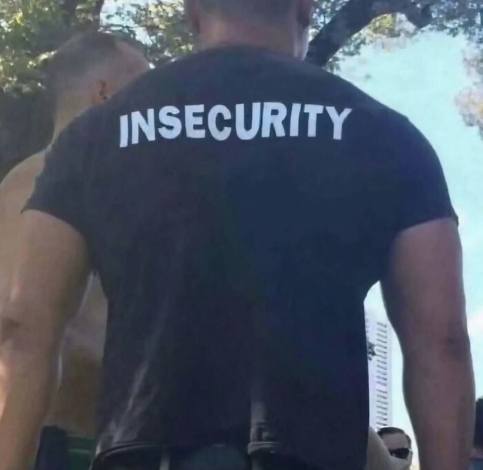 A hilarious pic of a man wearing a shirt that says INSECURITY on the back.