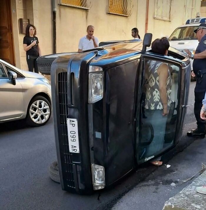 A black car flipped onto its side in a narrow street in one of these hilarious pics.