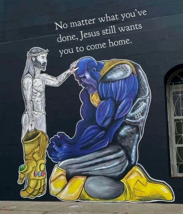Hilarious pics showing a wall painting of Jesus comforting a kneeling Thanos.