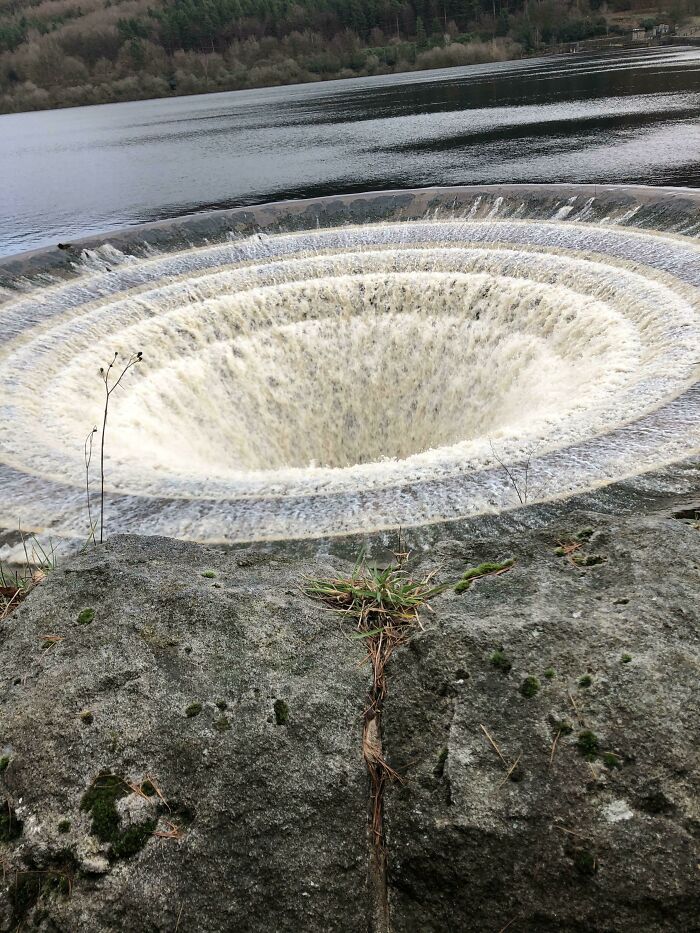 Circular deep water vortex or whirlpool funneling water in nature