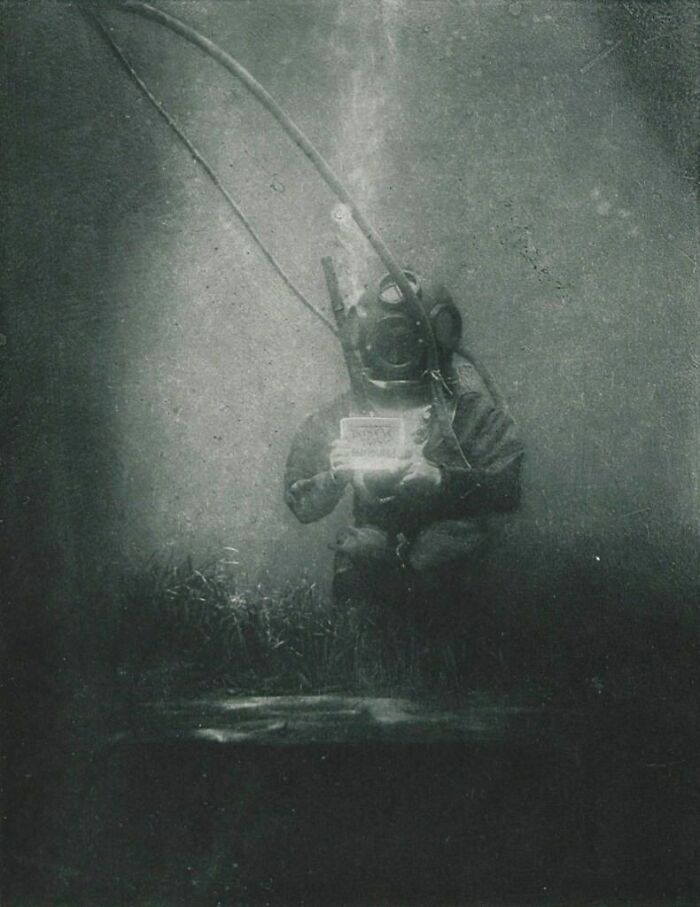 Vintage deep water diver wearing old diving suit underwater