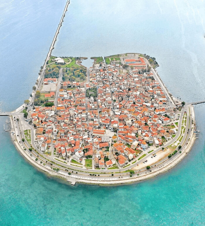 Aerial view of coastal town surrounded by blue ocean water