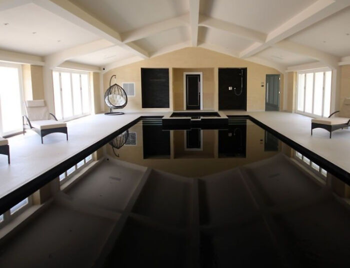 Interior of modern room with large black reflective deep water pool