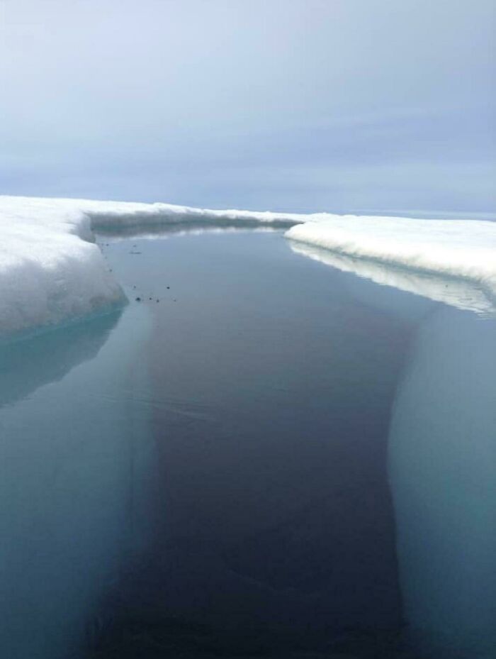 Dark, deep crevasse in icy water showing a creepy deep-water scene