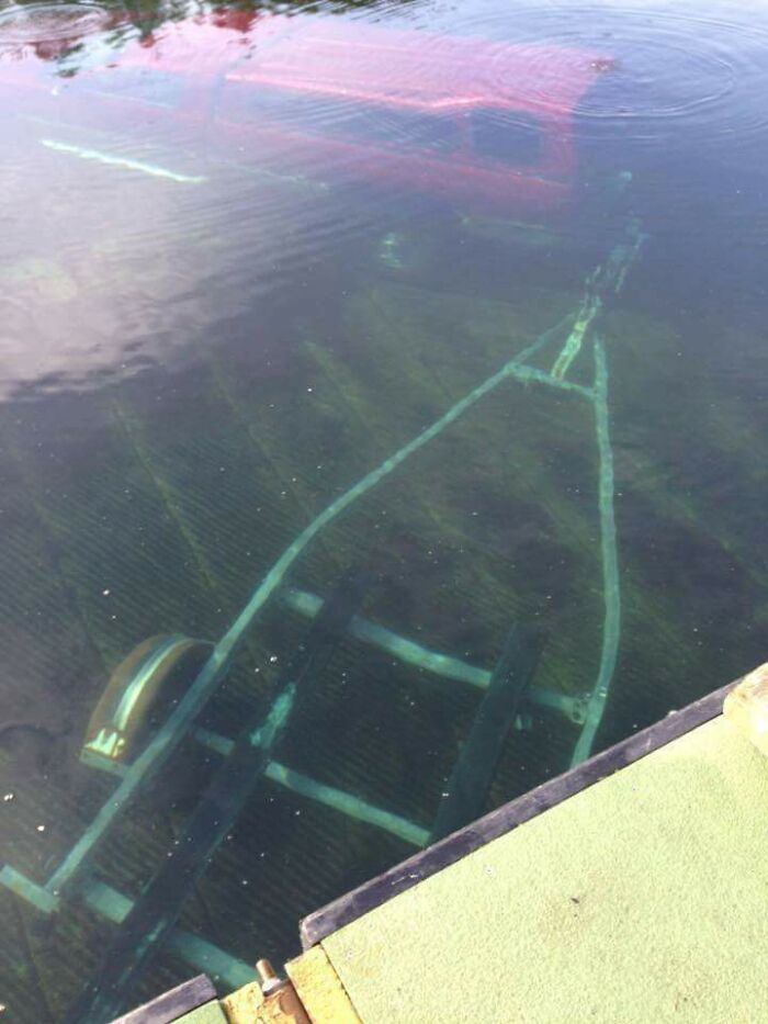 Submerged vehicle frame visible underwater in deep water photo