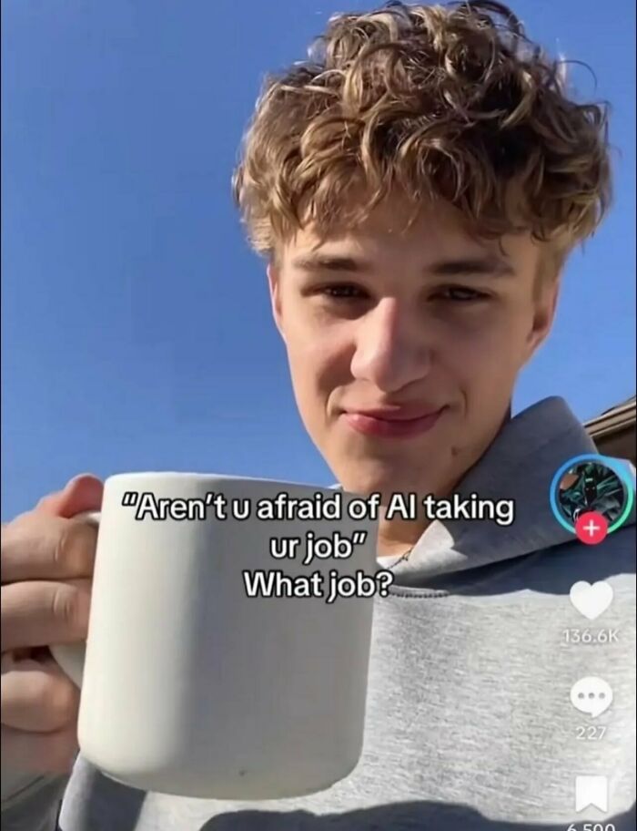 A young man holding a mug in a funny selfie about job loss to AI.