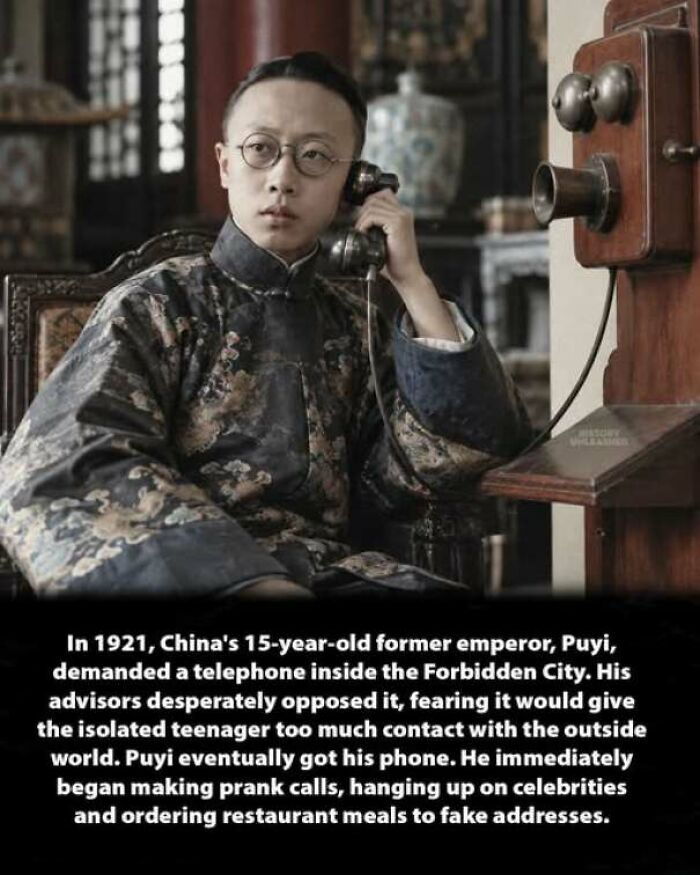 Young Emperor Puyi using a wall telephone, showing an interesting history moment in the Forbidden City.