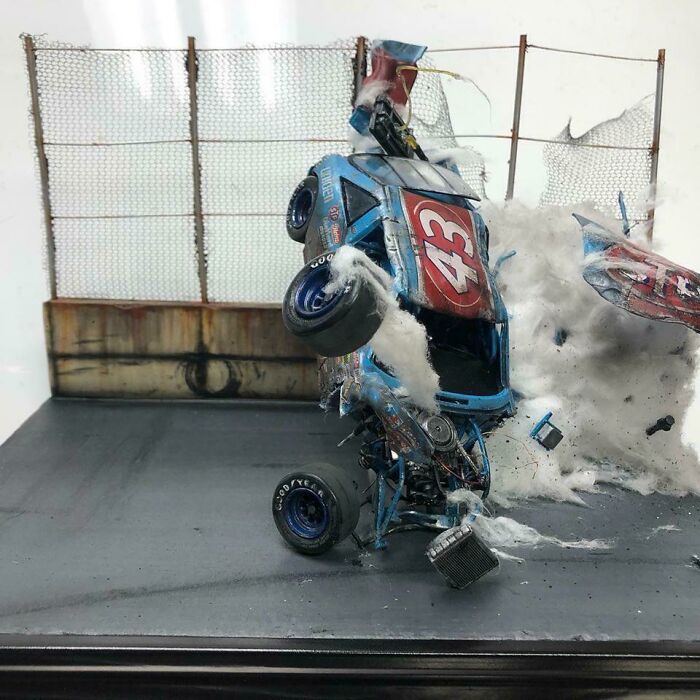 Miniature model capturing dramatic car crash with flying debris