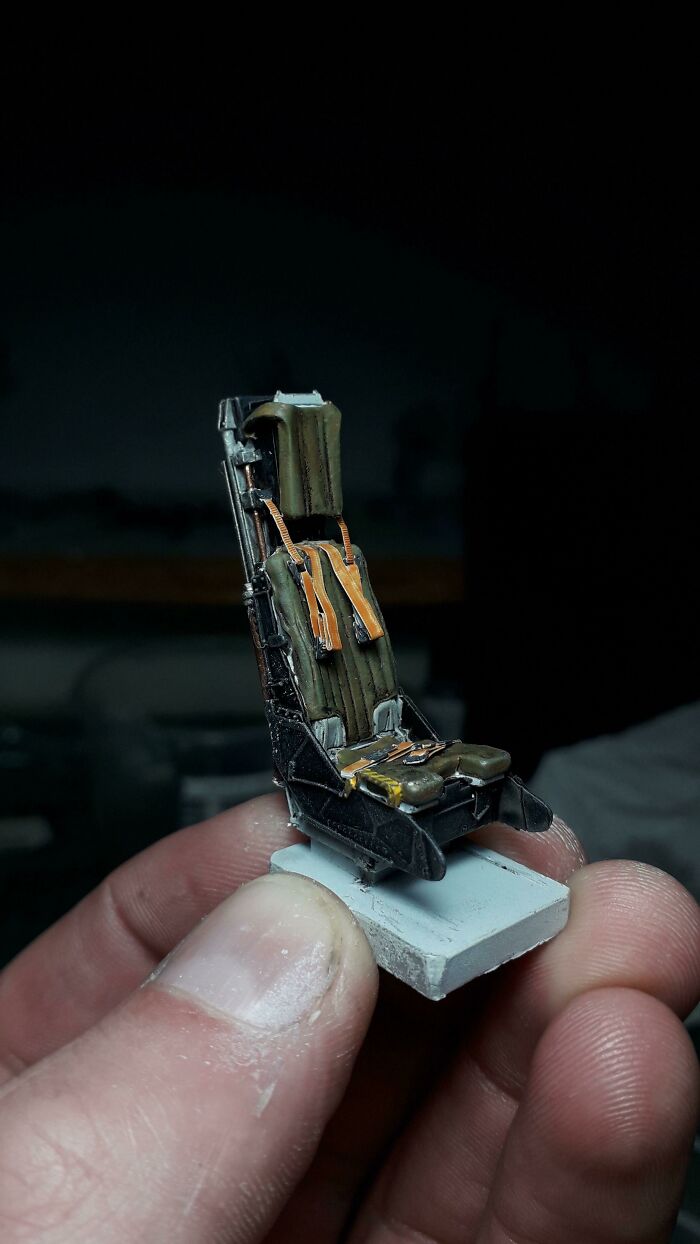 Close-up of a detailed miniature aircraft ejection seat with harness