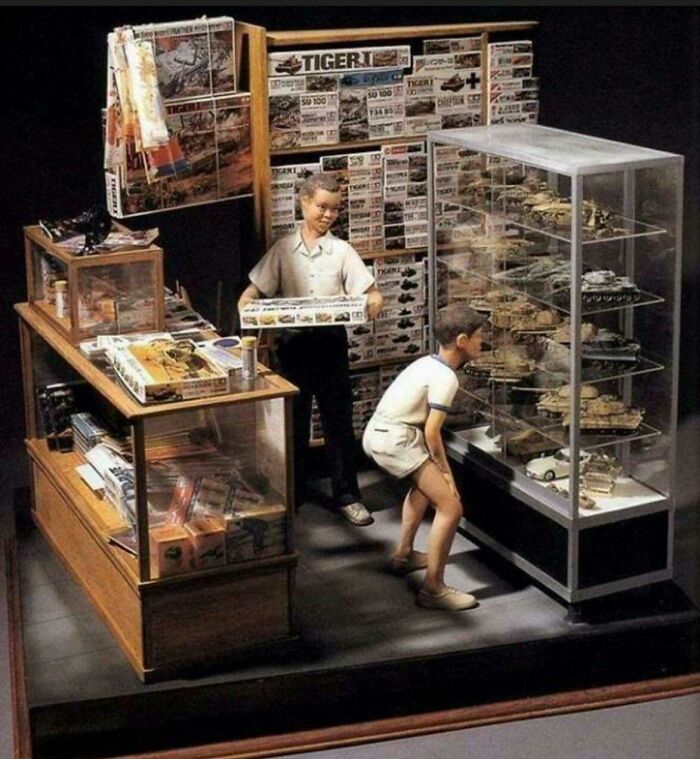 Miniature model shop display with figures and tanks portraying detailed craftsmanship