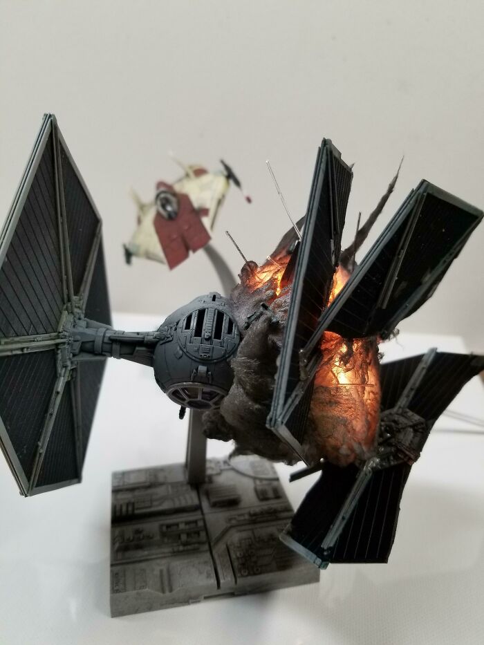 Miniature Star Wars TIE fighter models with explosion effects in a dynamic scene