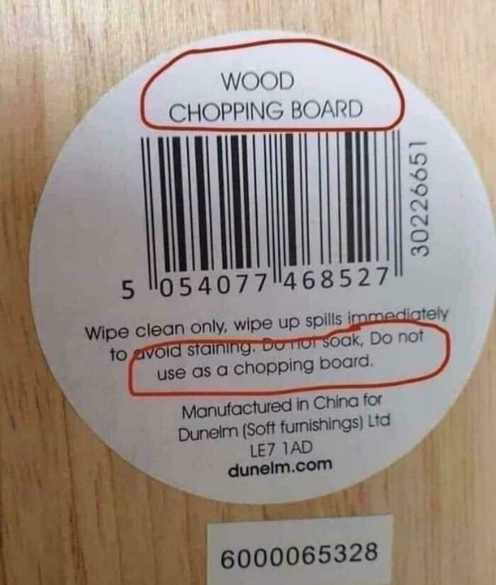 Confusing labels on a wood chopping board advising not to use it as a chopping board.