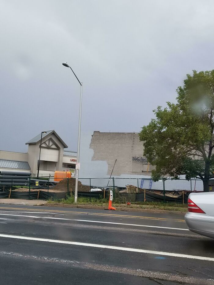 Grey wall missing part of its construction in a construction site