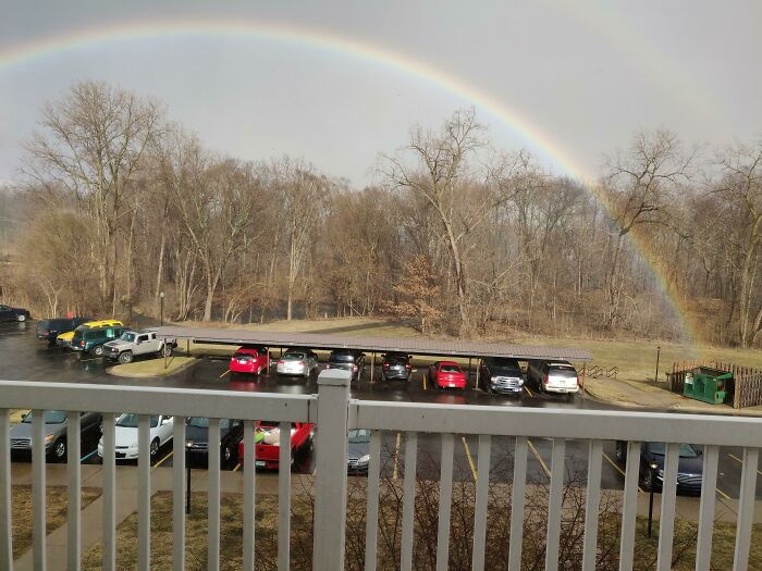 Rainbow over parking lot and trees glitch matrix scene