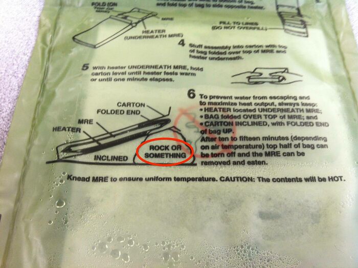 Military MRE packet with a hilarious diagram pointing to a rock or something to lean the heater on.