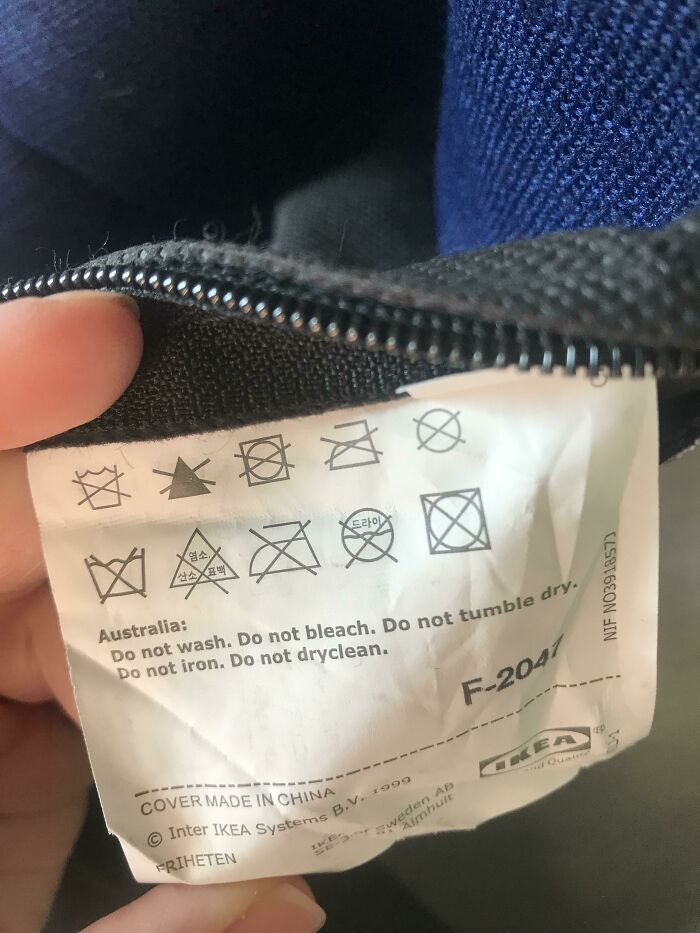 An IKEA fabric tag showing funny confusing labels and care instructions stating not to wash or dry clean.