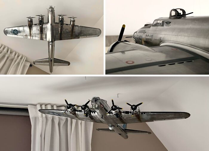 Highly detailed silver miniature World War II bomber airplane model hanging indoors