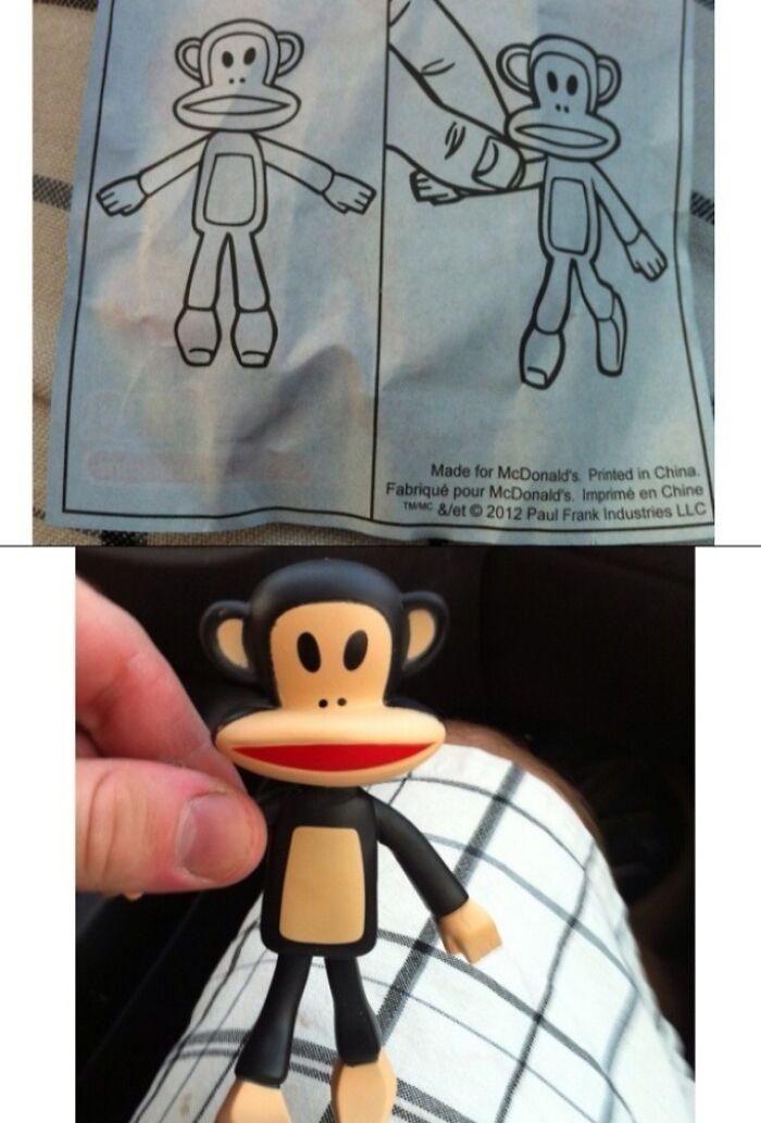 A black monkey toy held next to its confusing labels and instructions sheet