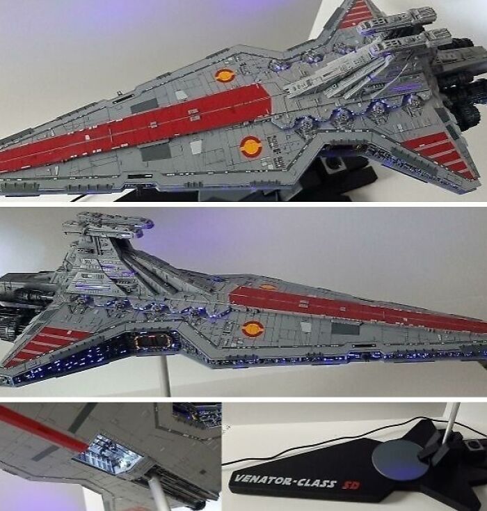 Miniature model of a starship with detailed gray and red color scheme and lighting effects