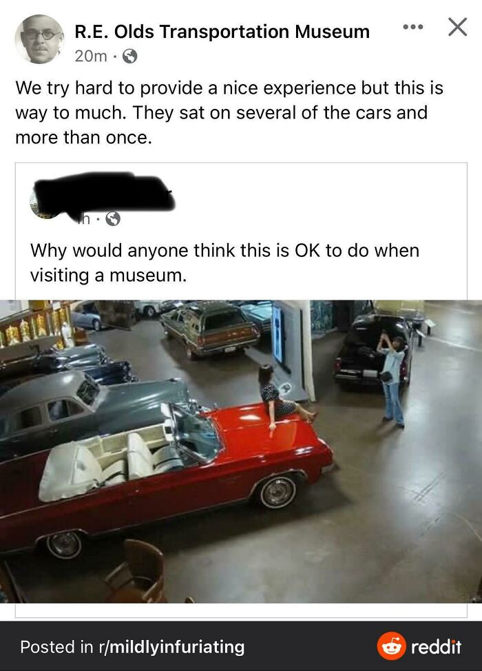 Influencers in public spaces posing sitting directly on a vintage red convertible car inside a museum