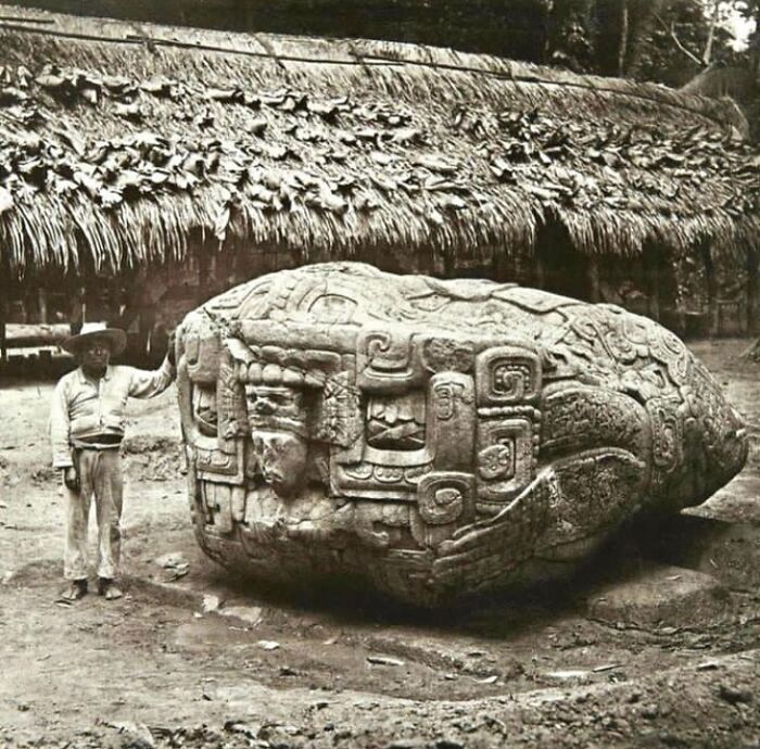 Massive ancient stone carving next to a man, showing surprising facts about the past.
